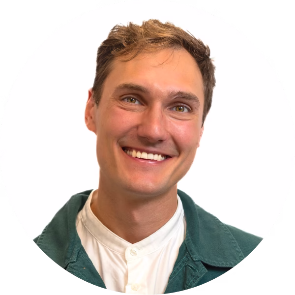 Photo of young man in a white shirt smiling