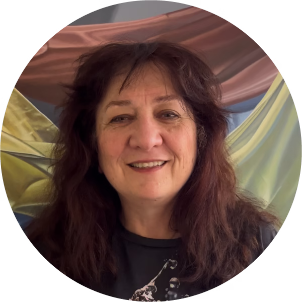 photo of woman with brown hair in front of a painting