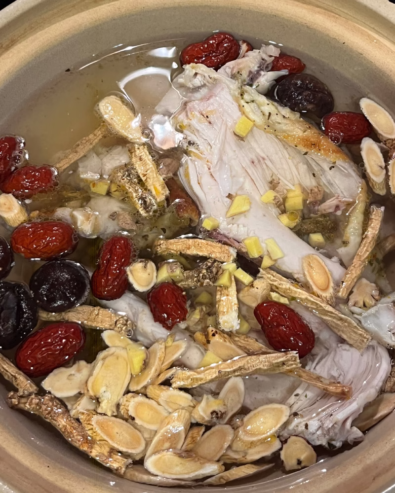 homemade chicken soup with herbs and traditional Chinese medicine ingredients