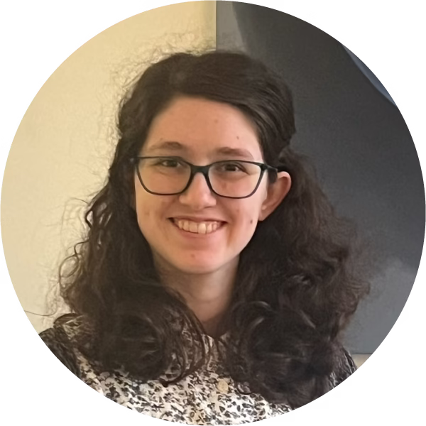photo of young woman with glasses and brown hair in front of a painting